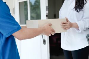 Marijuana Delivery Independent Operators, A delivery person hands a package to a customer.