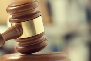 Close-up of a wooden gavel symbolizing court authority and contempt of court.