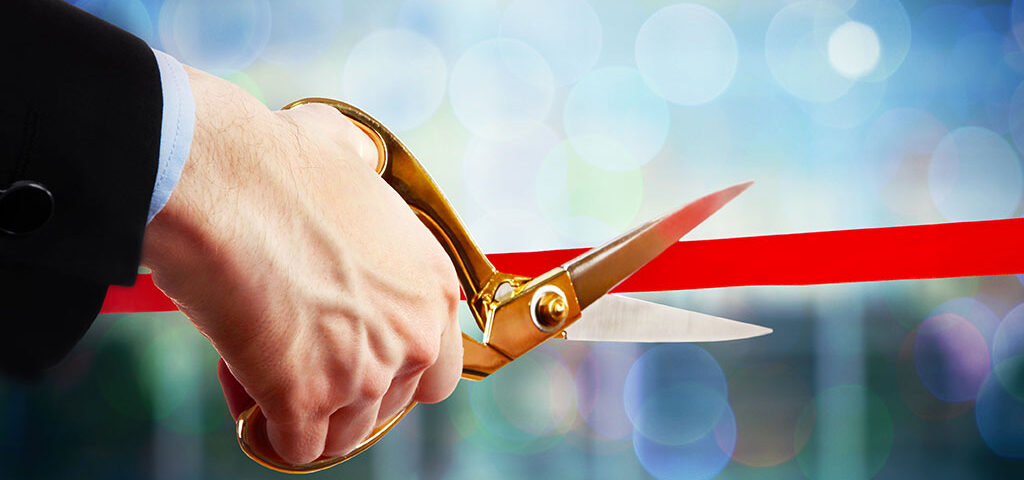 Ribbon-cutting ceremony symbolizing steps to obtain an alcohol license in Boston, Massachusetts.