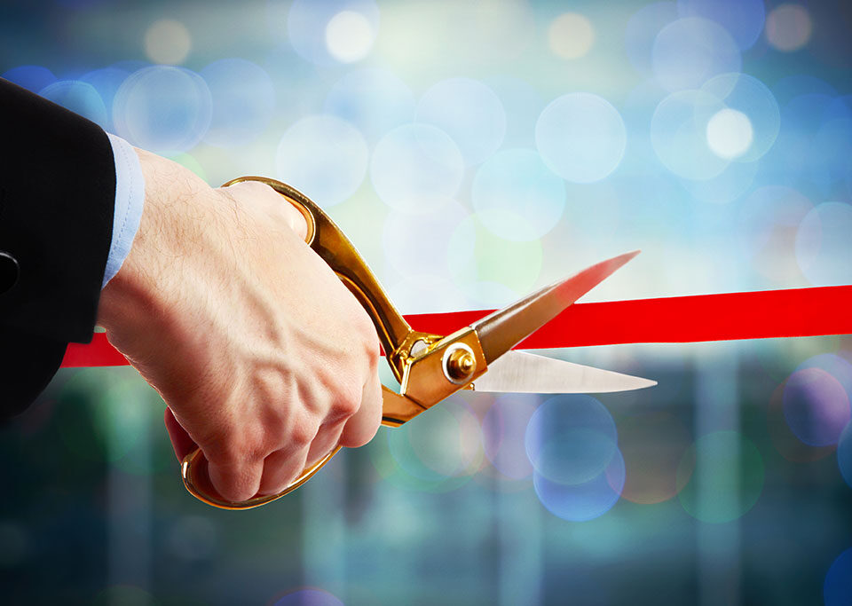 Ribbon-cutting ceremony symbolizing steps to obtain an alcohol license in Boston, Massachusetts.